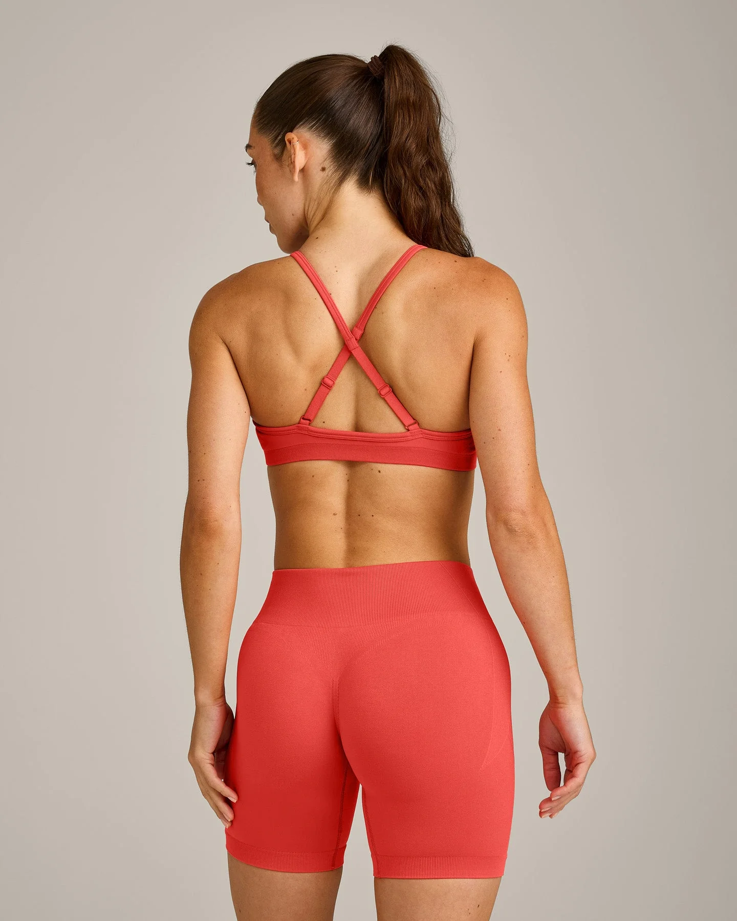 EnhanceLift™ Seamless Strappy Sports Bra with Grey Logo | Dark Charged Coral - Image 6