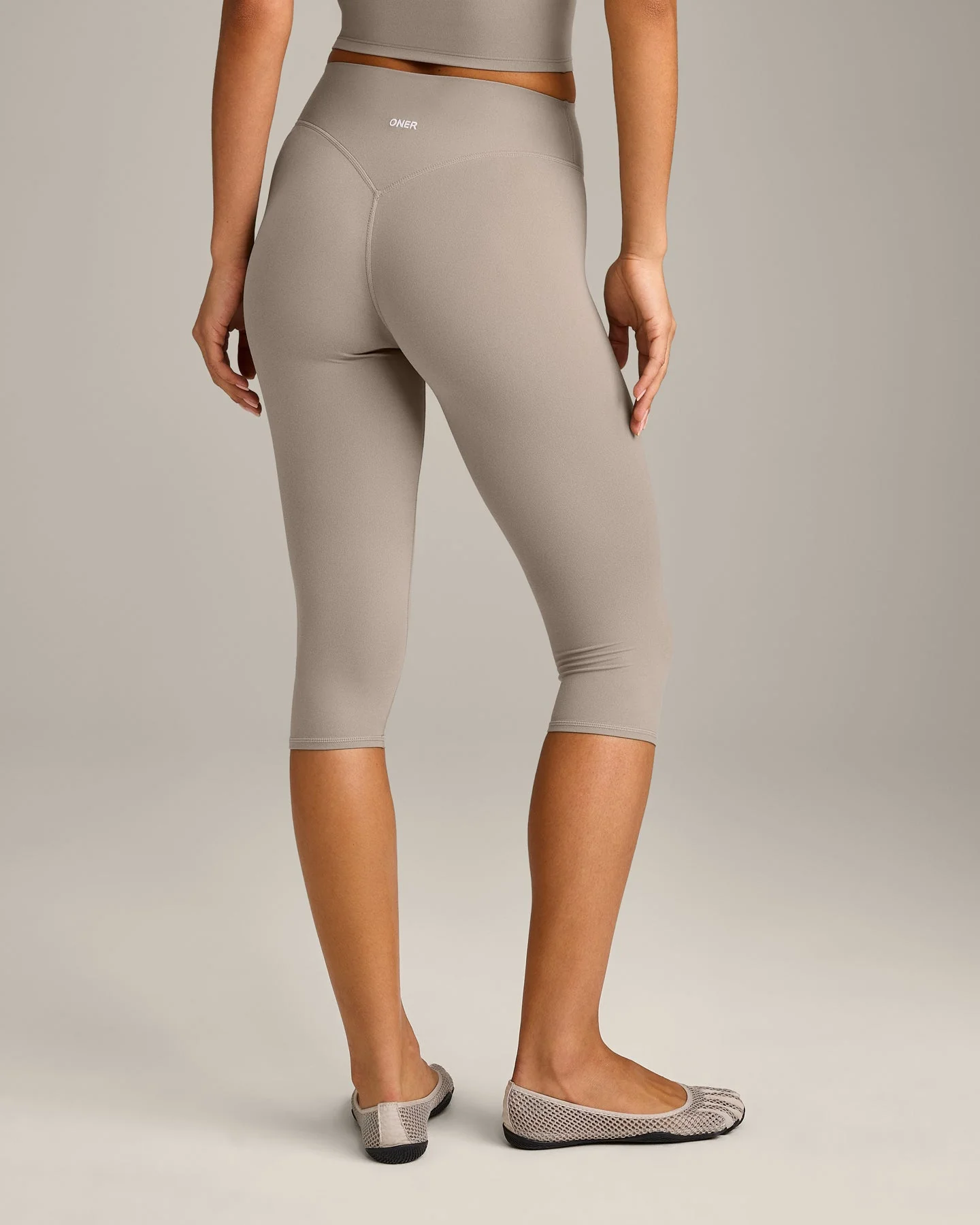 SoftMotion™ High Waisted Capri Leggings with White Logo | Warm Sand