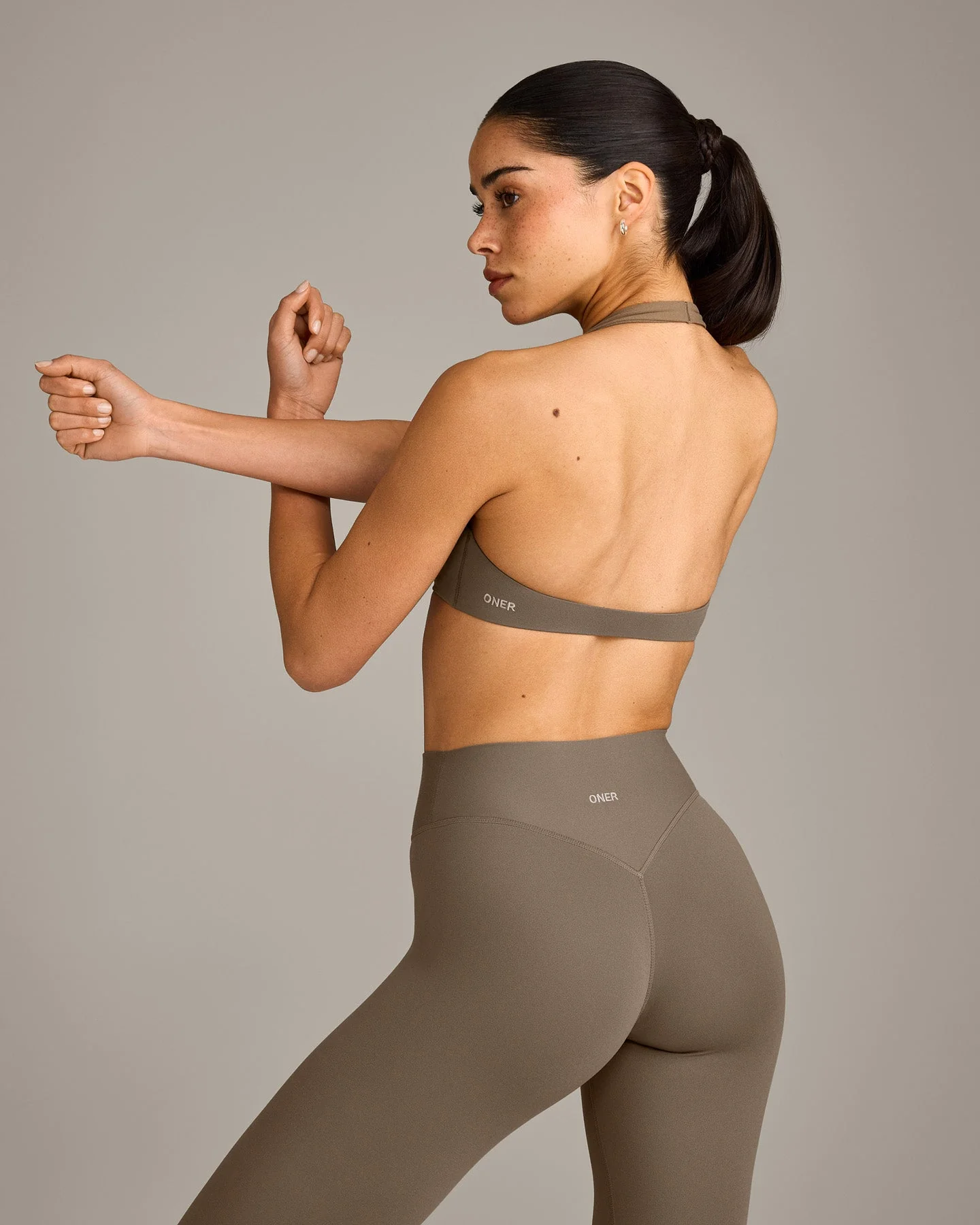 SoftMotion™ Minimal Halter Neck Bralette with Grey Logo | Moss Brown - Image 2