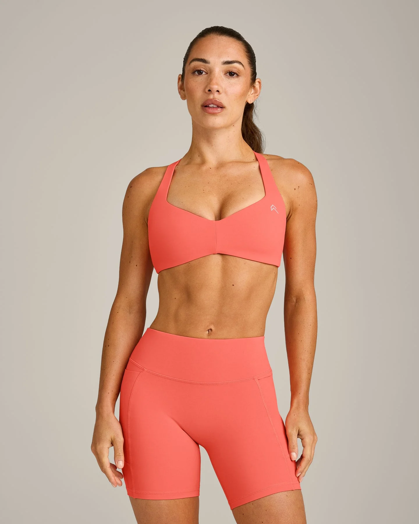 UnifiedMove™ T Back Minimal Bralette with Reflective Logo | Light Charged Coral